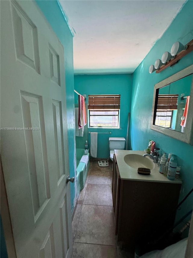 bathroom with toilet, shower / tub combo, and vanity