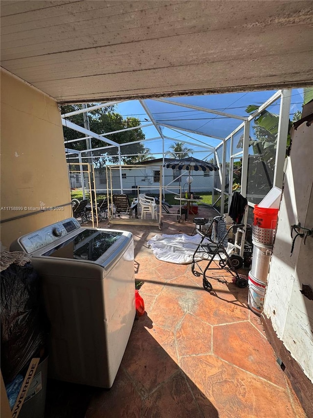 view of patio / terrace with washer / clothes dryer, fence, and a lanai