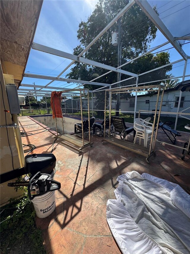 view of patio / terrace featuring glass enclosure