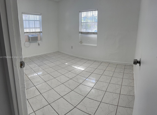 empty room featuring baseboards and a healthy amount of sunlight