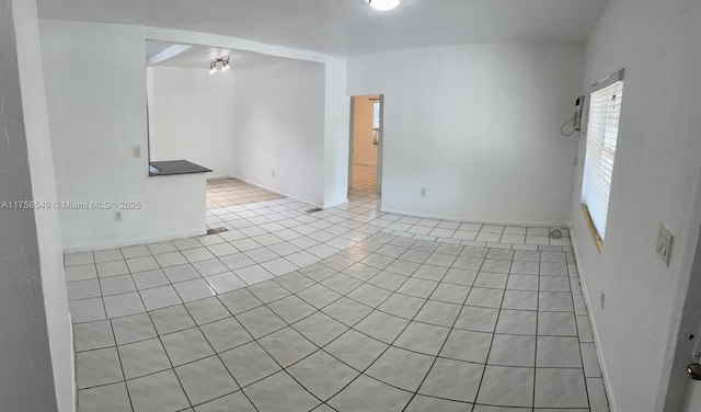 unfurnished room featuring light tile patterned floors