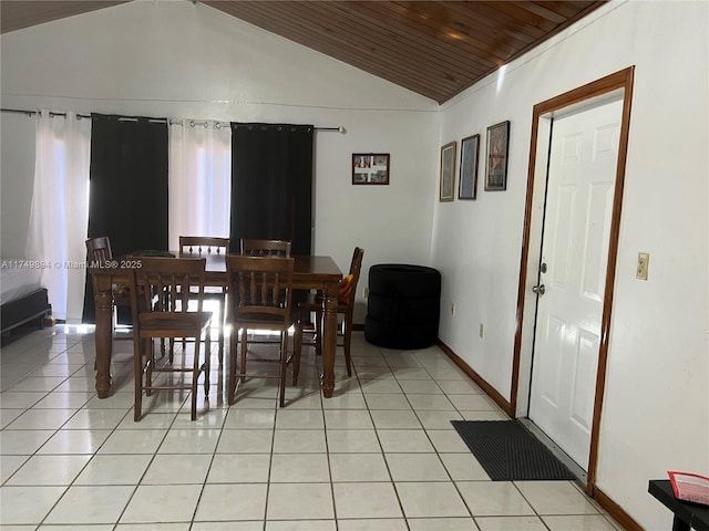 dining room with wood ceiling, light tile patterned flooring, vaulted ceiling, and baseboards