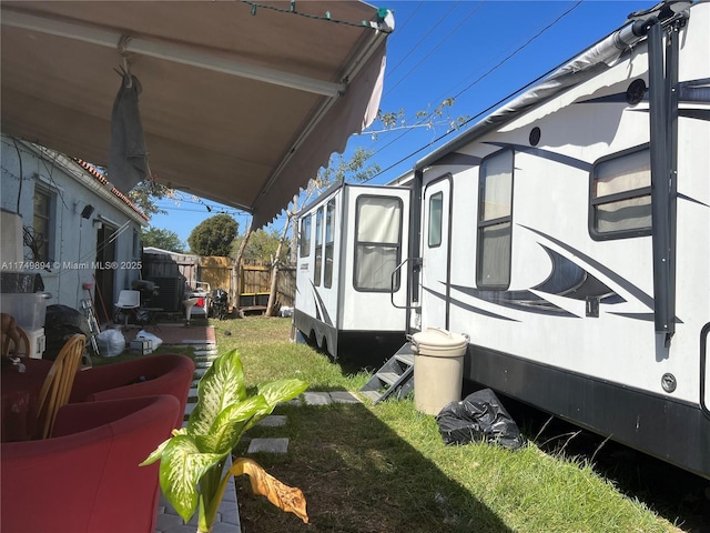 view of side of home featuring fence