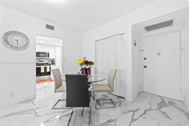 dining area featuring marble finish floor and visible vents