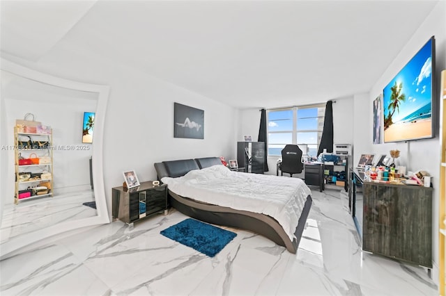 bedroom featuring marble finish floor
