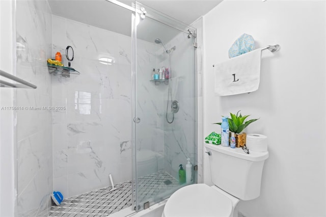 full bath with a marble finish shower and toilet