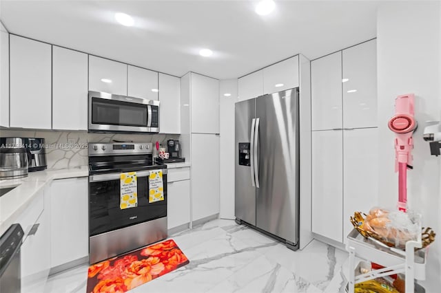 kitchen featuring appliances with stainless steel finishes, light countertops, white cabinets, and modern cabinets