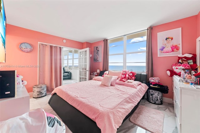 bedroom featuring french doors and multiple windows