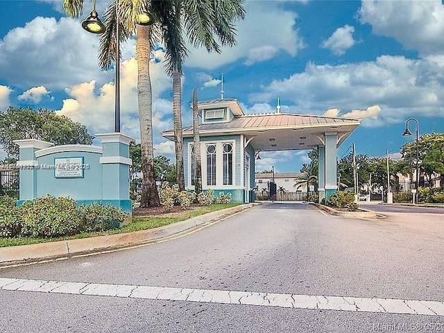 view of road with street lighting and curbs