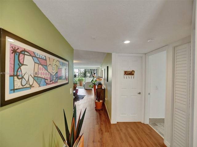 hall with recessed lighting, baseboards, and wood finished floors