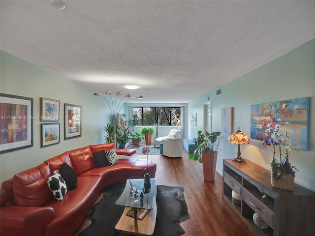 living area featuring visible vents, a textured ceiling, and wood finished floors