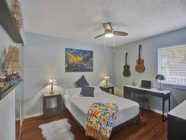 bedroom featuring ceiling fan, wood finished floors, baseboards, and a textured ceiling