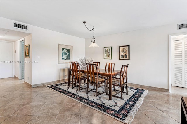 dining area featuring light tile patterned floors, visible vents, and baseboards
