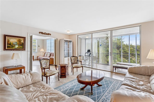 living area featuring light tile patterned floors and a wall of windows