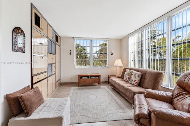 living room featuring baseboards and light tile patterned flooring
