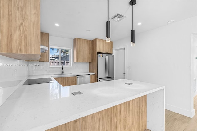 1116 N 31st Ave, Hollywood, FL 33021 - kitchen featuring appliances with stainless steel finishes, modern cabinets, a peninsula, backsplash, and light wood-type flooring