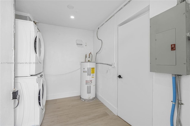 1116 N 31st Ave, Hollywood, FL 33021 - washroom featuring stacked washer / drying machine, electric water heater, electric panel, light wood finished floors, and recessed lighting