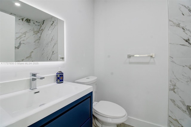 bathroom featuring toilet and vanity