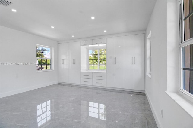 unfurnished room featuring recessed lighting, marble finish floor, visible vents, and baseboards