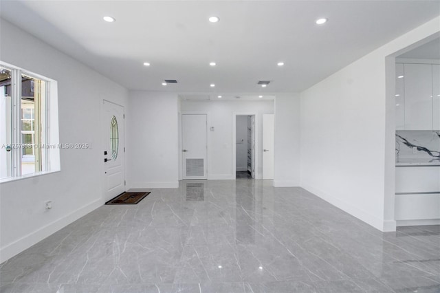 unfurnished room with marble finish floor, visible vents, baseboards, and recessed lighting