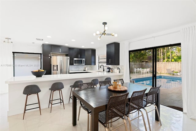 dining area featuring recessed lighting, visible vents, and an inviting chandelier