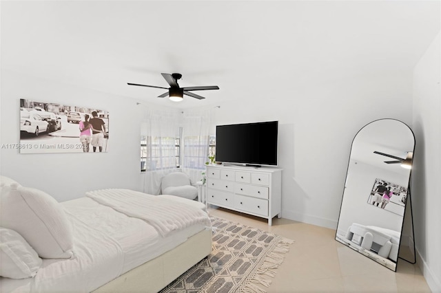 bedroom featuring ceiling fan and baseboards