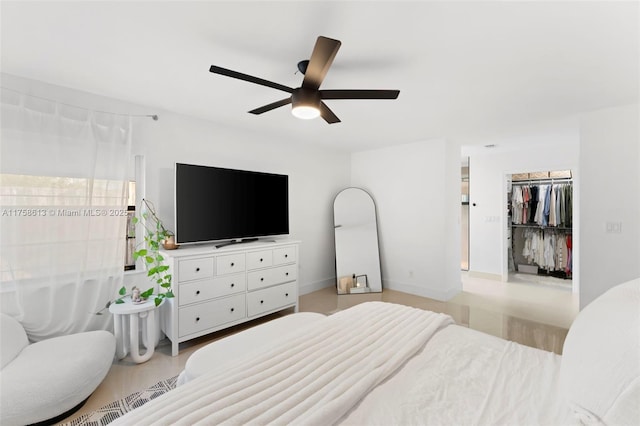 bedroom featuring a spacious closet and a ceiling fan