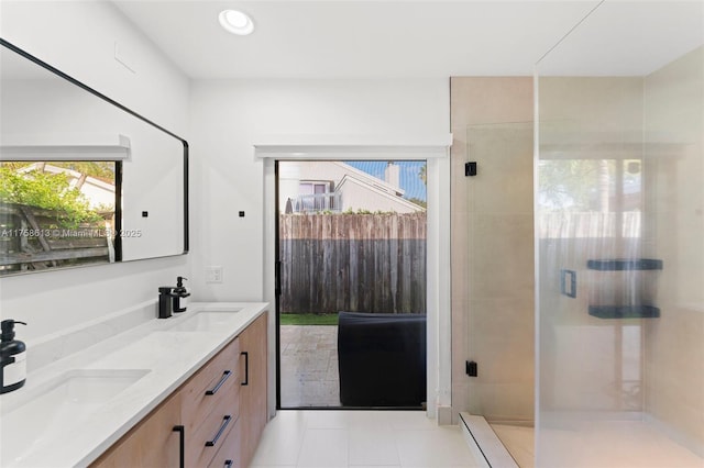 bathroom featuring a stall shower, a sink, recessed lighting, and double vanity