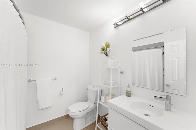 bathroom with vanity, wood finished floors, toilet, and a shower with curtain