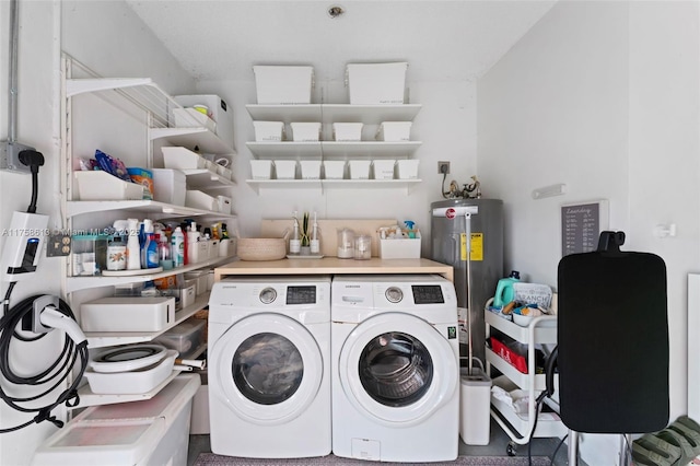 laundry area with laundry area, water heater, and washing machine and clothes dryer