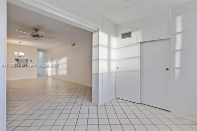 unfurnished room featuring ceiling fan, light tile patterned flooring, and visible vents