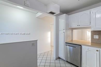 kitchen with visible vents, white cabinets, light countertops, dishwasher, and tasteful backsplash