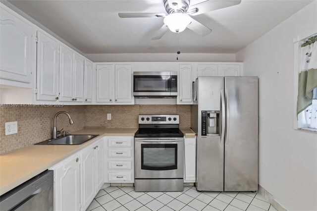 330 NE 26th Ave Unit 4160, Boynton Beach, FL 33435 - kitchen with appliances with stainless steel finishes, white cabinetry, backsplash, light countertops, and a ceiling fan