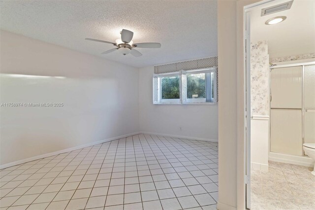 330 NE 26th Ave Unit 4160, Boynton Beach, FL 33435 - empty room featuring a ceiling fan, light tile patterned floors, and a textured ceiling