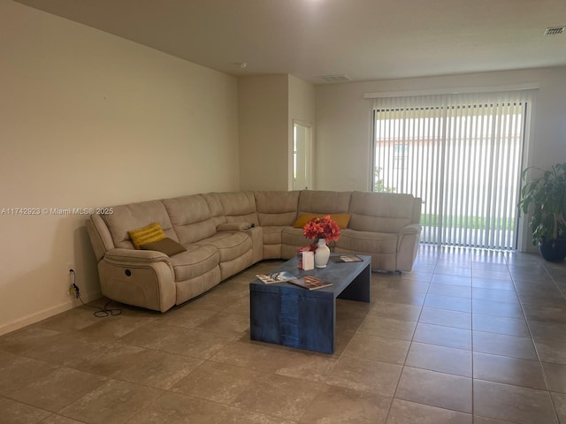 tiled living area with visible vents and baseboards