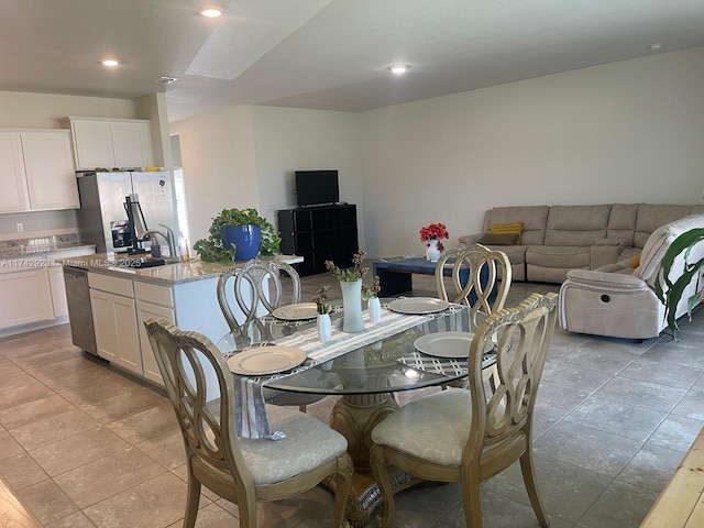 dining space featuring light tile patterned floors and recessed lighting