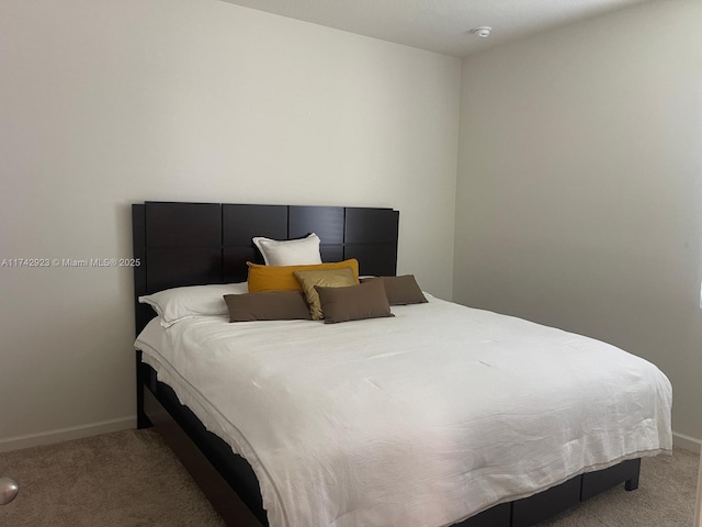 bedroom with carpet flooring and baseboards