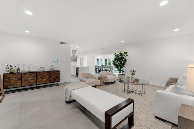 living area with recessed lighting, concrete flooring, and baseboards