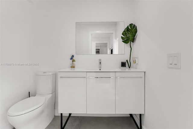 bathroom with toilet, vanity, and finished concrete flooring