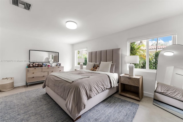 bedroom featuring visible vents and baseboards