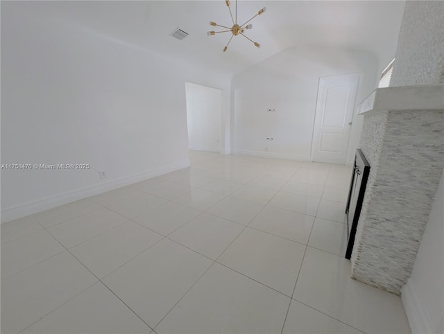 unfurnished room with light tile patterned floors, lofted ceiling, visible vents, baseboards, and an inviting chandelier