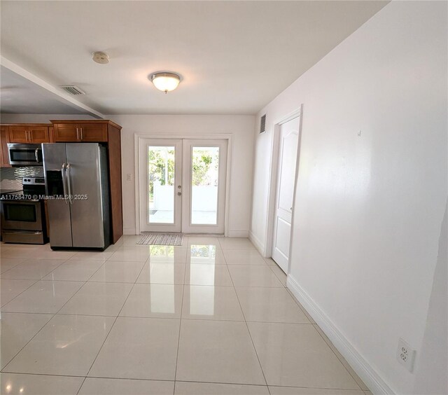 755 NE 88th St, Miami, FL 33138 - kitchen featuring light tile patterned floors, french doors, visible vents, and stainless steel appliances