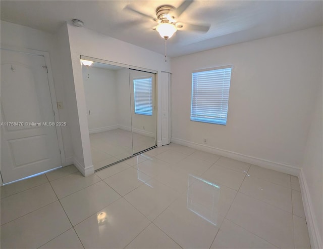 755 NE 88th St, Miami, FL 33138 - unfurnished bedroom with light tile patterned floors, baseboards, a closet, and a ceiling fan