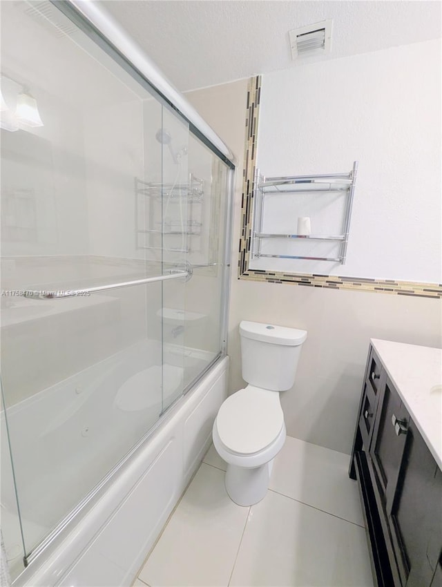 755 NE 88th St, Miami, FL 33138 - bathroom with vanity, visible vents, bath / shower combo with glass door, tile patterned flooring, and toilet