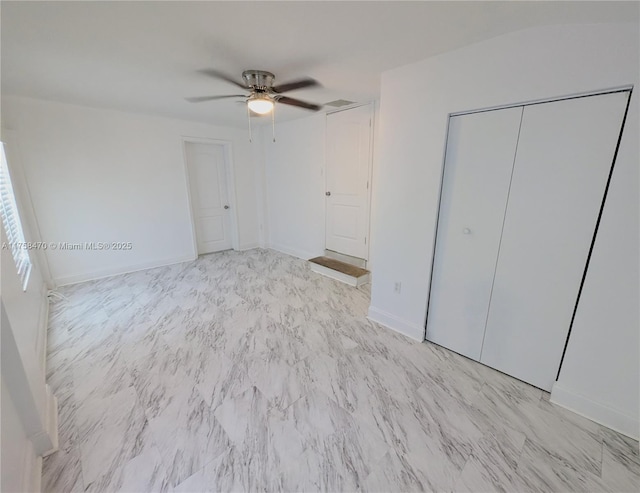 755 NE 88th St, Miami, FL 33138 - unfurnished bedroom with a closet, marble finish floor, a ceiling fan, and baseboards