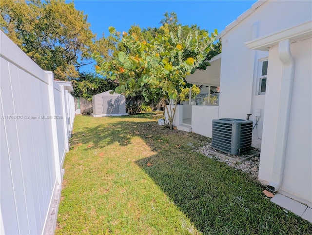 755 NE 88th St, Miami, FL 33138 - view of yard featuring an outbuilding, central AC, a fenced backyard, and a shed