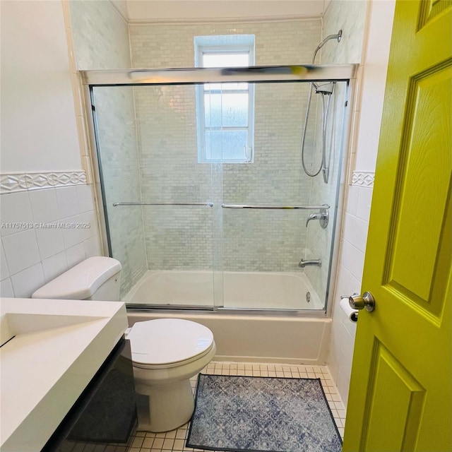 bathroom featuring bath / shower combo with glass door, tile walls, and tile patterned floors