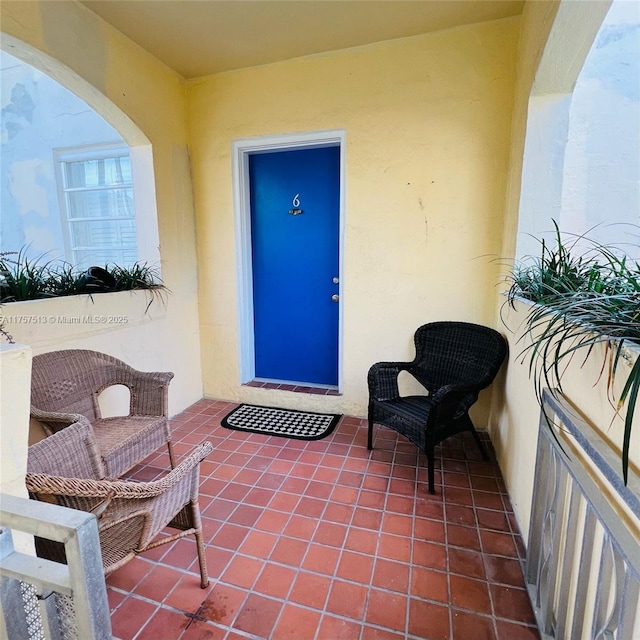 entrance to property featuring a patio and stucco siding