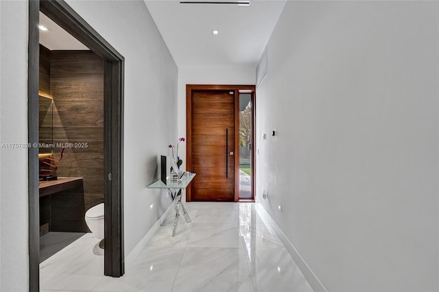 interior space featuring marble finish floor and baseboards