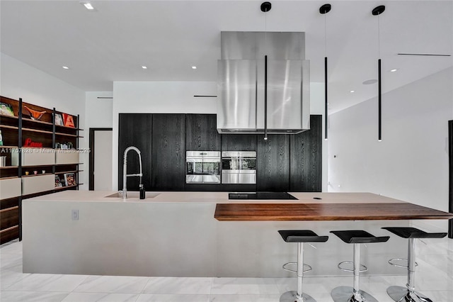 kitchen featuring stainless steel oven, recessed lighting, a sink, and black electric stovetop